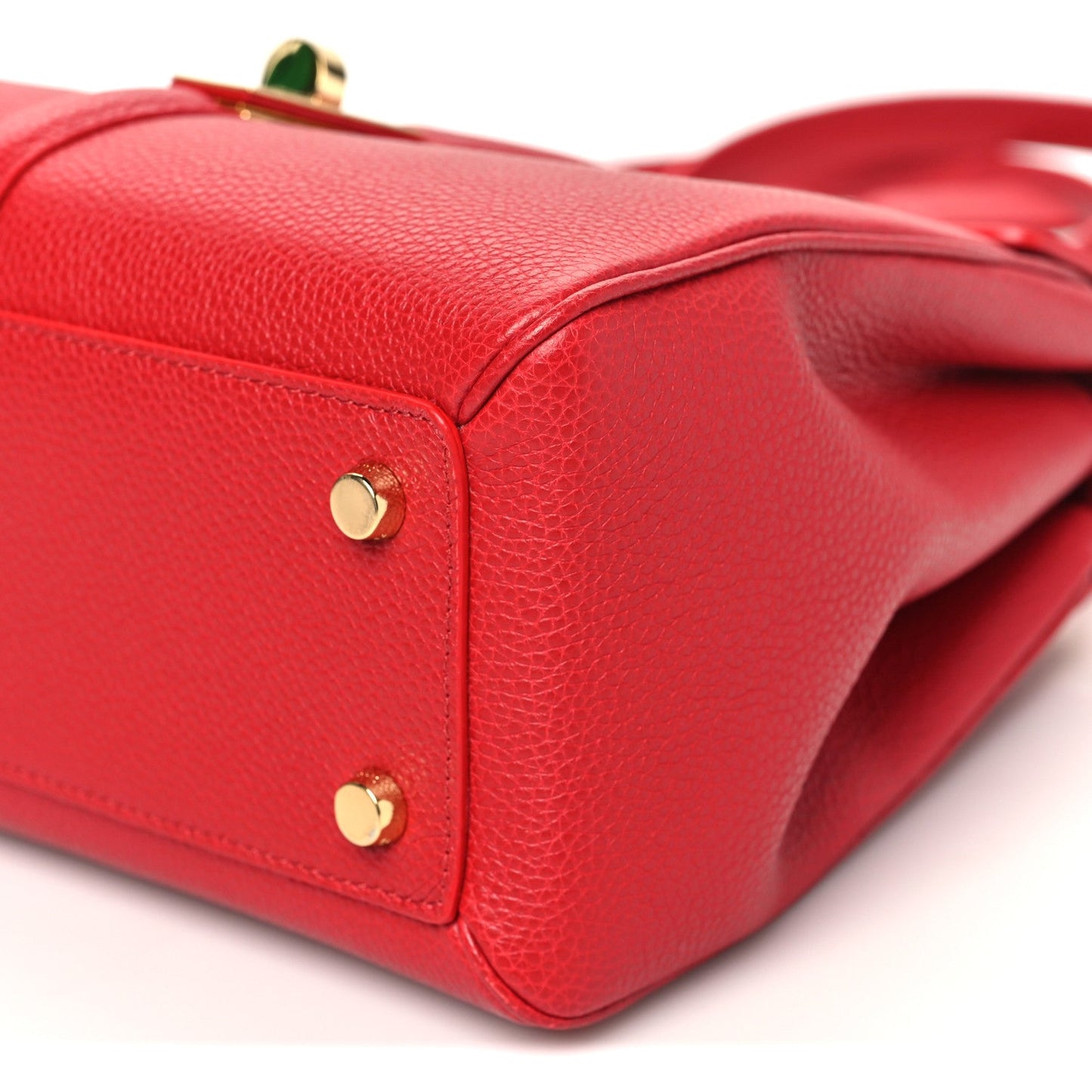 Celine small red bag with gold corner hardware and pebbled leather edge seam.