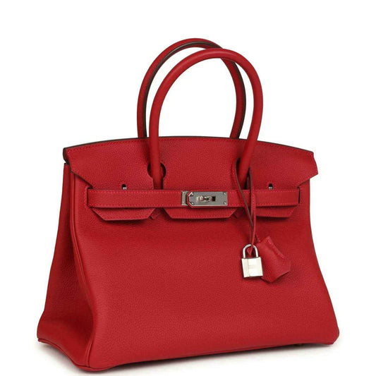 Elegant red leather handbag with silver hardware and a timeless, sophisticated design
