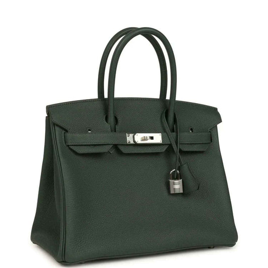 Elegant dark green leather handbag with silver hardware, timeless and sophisticated style.