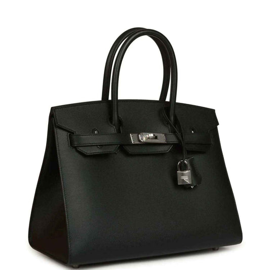 Timeless black leather handbag with elegant silver hardware and structured silhouette.
