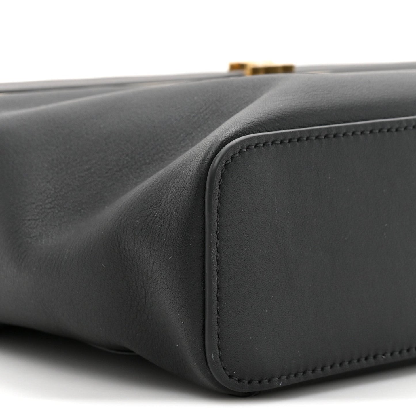 Black leather rectangle bag side corner with rounded panel and edge stitching