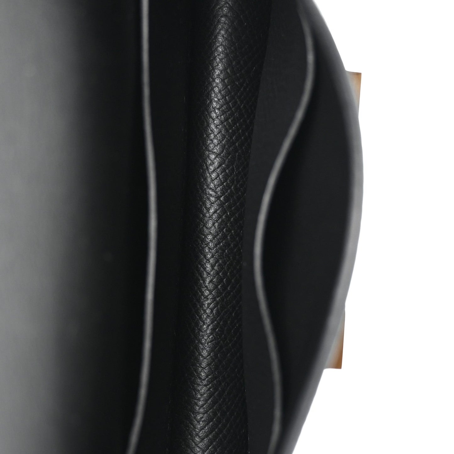 Hermes Constance slim wallet black leather edge close-up with contrast stitching
