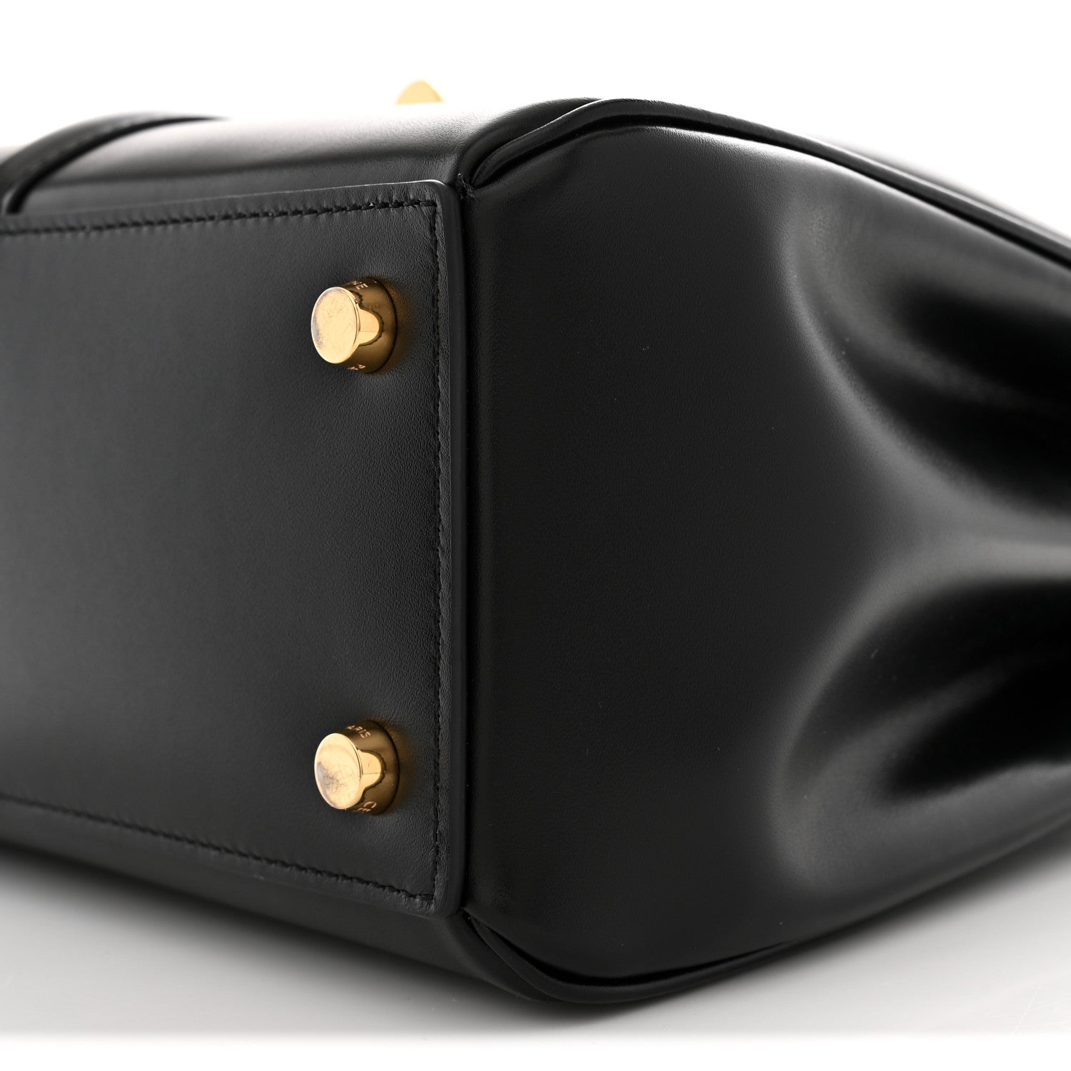 Black leather corner with two gold snap studs and smooth satin finish