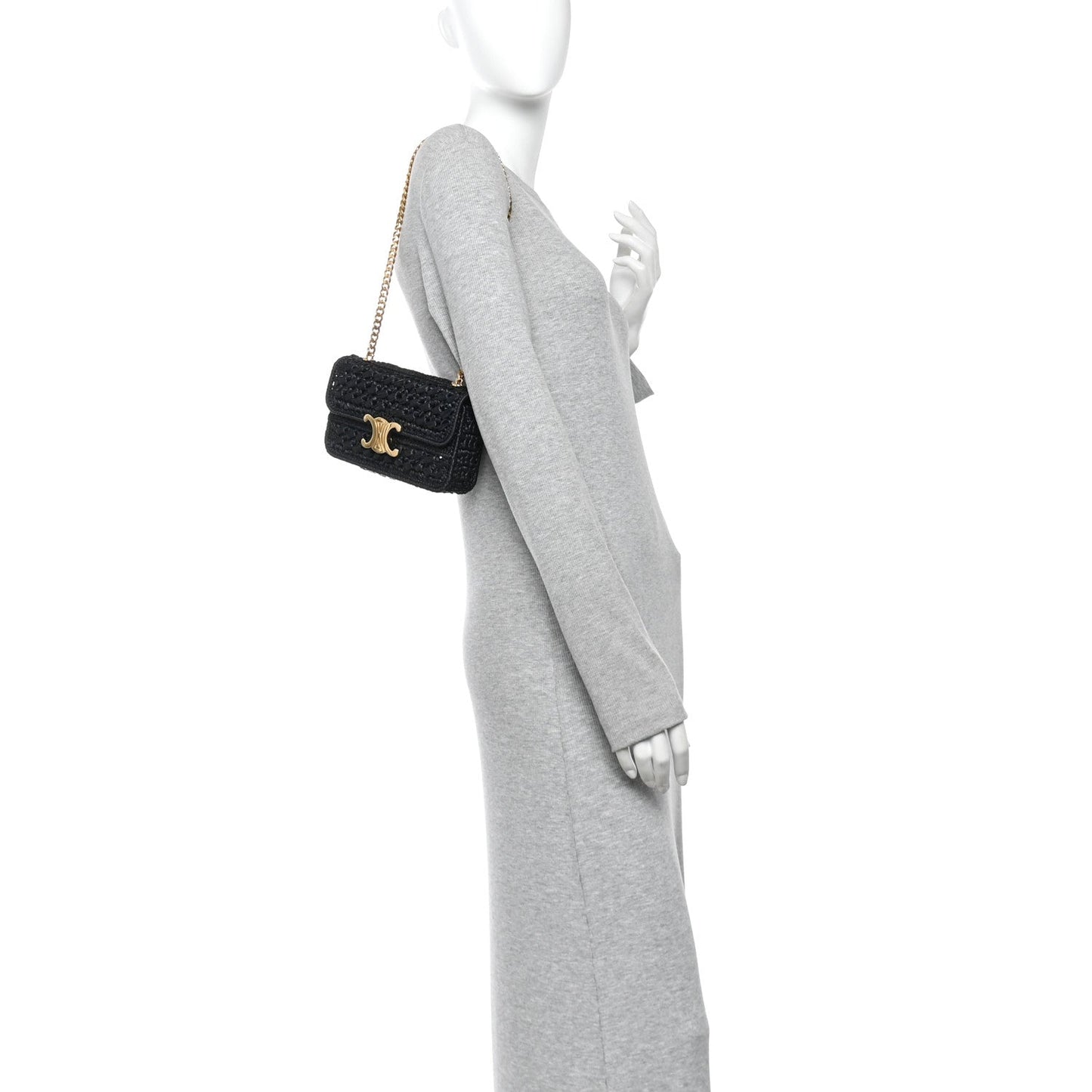 Black chain shoulder bag with gold CC logo, worn crossbody on a model