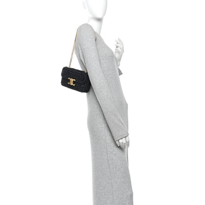 Black chain shoulder bag with gold CC logo, worn crossbody on a model