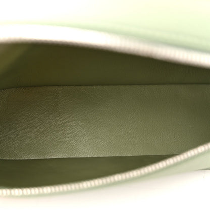 Sage green leather pouch interior with top zipper edge visible