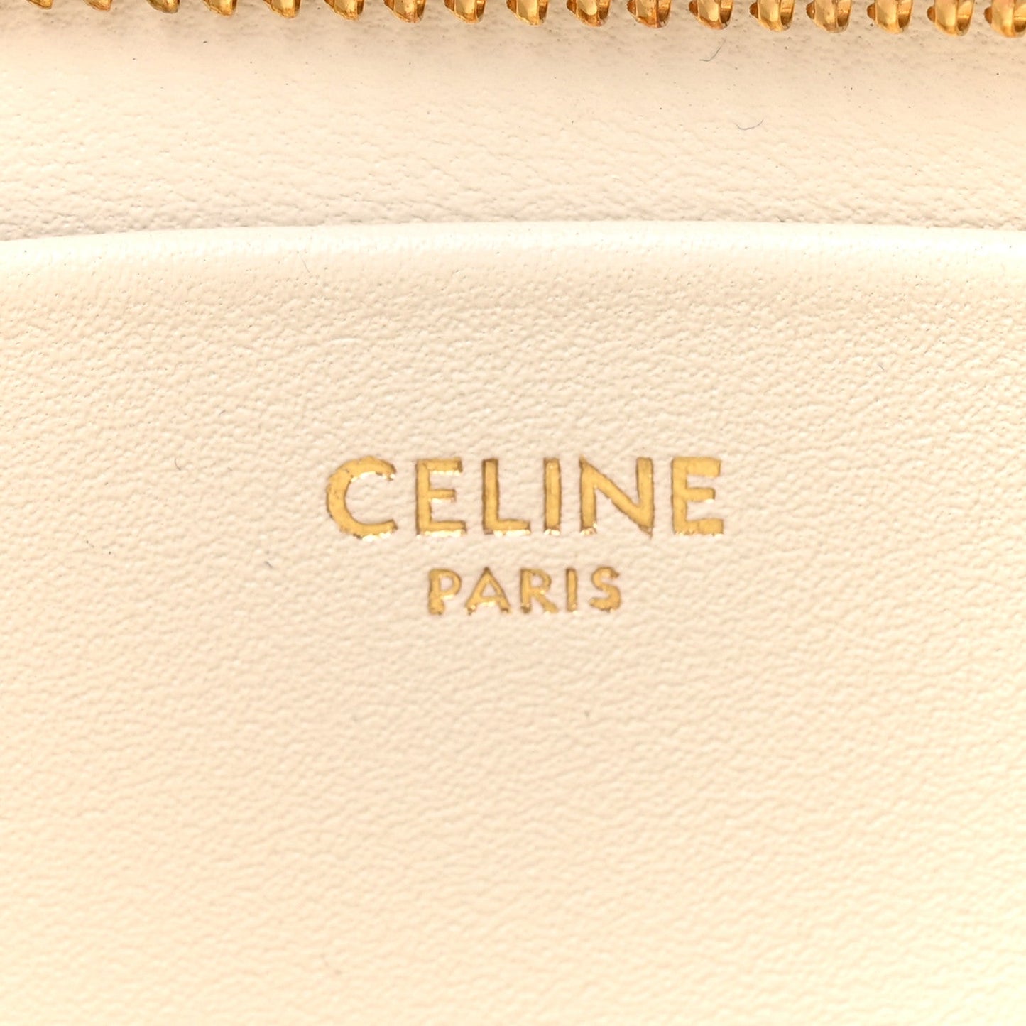 Celine Paris text on light rice cream leather with zipper edge