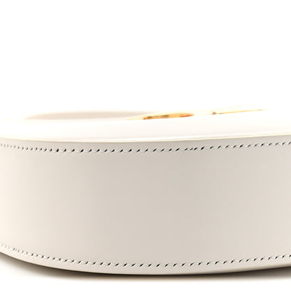 Close-up of rice cream bag side with gold-tone zipper pull and stitched trim