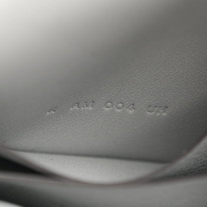 Hermes Constance slim wallet embossed markings on light blue leather interior.