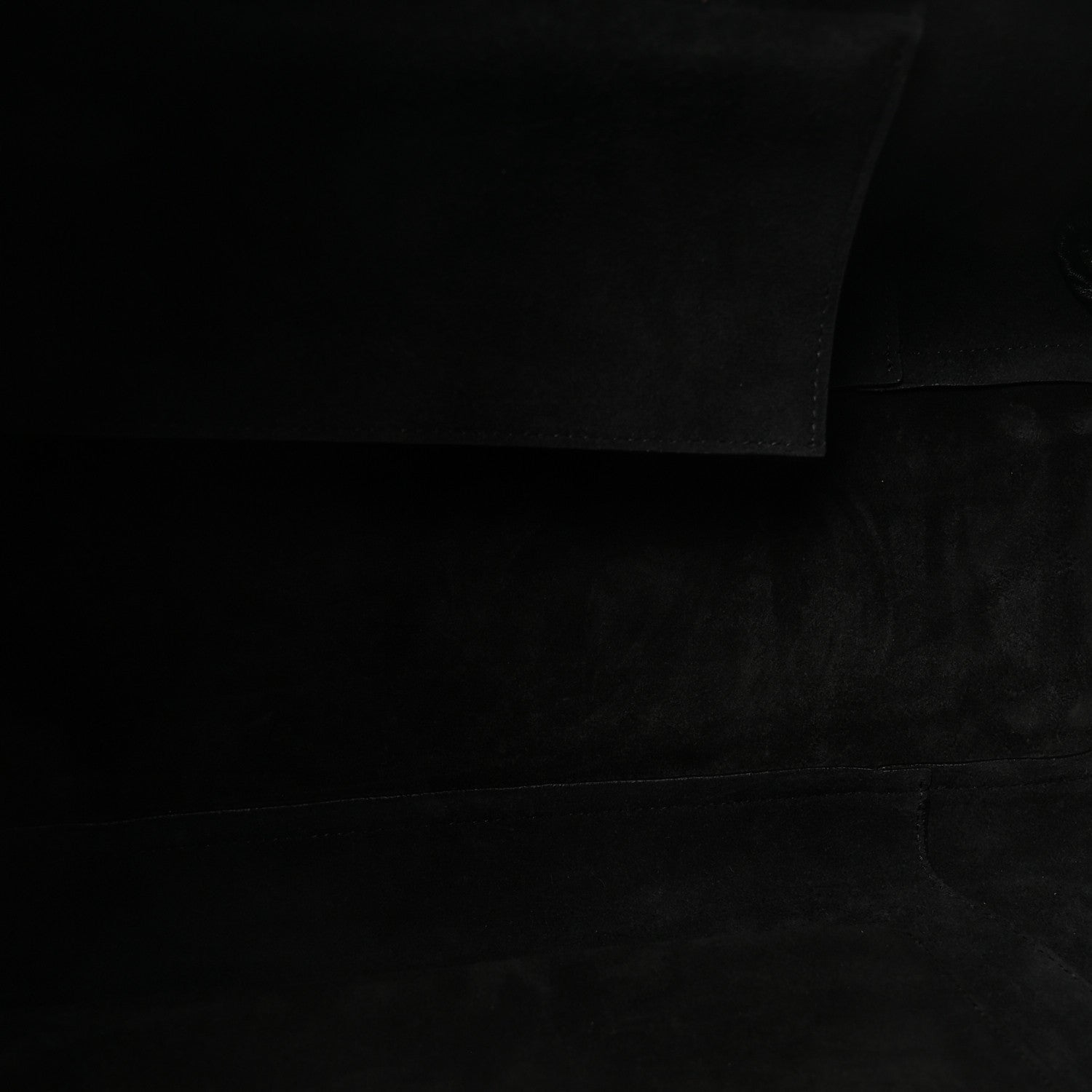Black leather bag interior lining fabric panel.