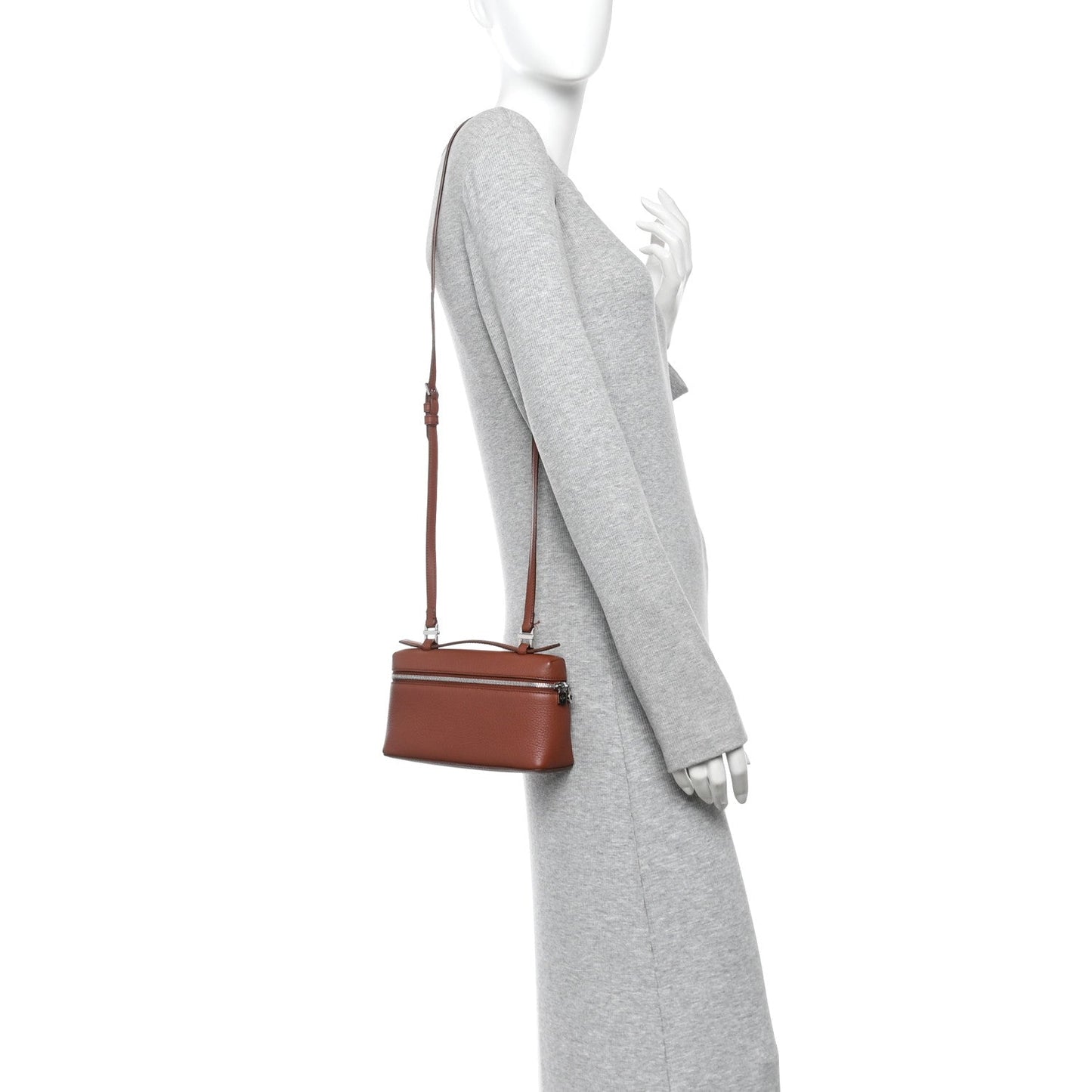 Grained calfskin crossbody pouch on mannequin with adjustable leather shoulder strap