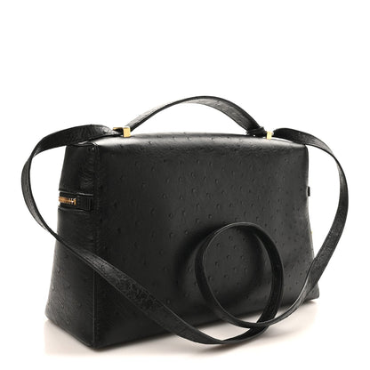 Black ostrich leather satchel with front zipper, wide strap, and gold-tone accents.