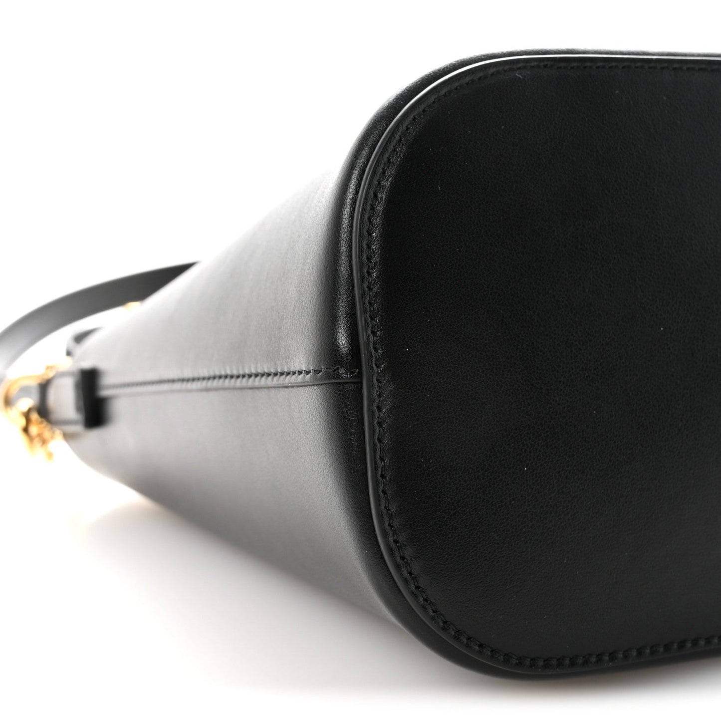 Side view of small black Celine bucket bag with smooth leather and gold hardware