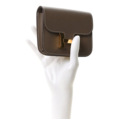 Hermes Constance slim wallet, etoupe textured leather, gold H clasp, side view