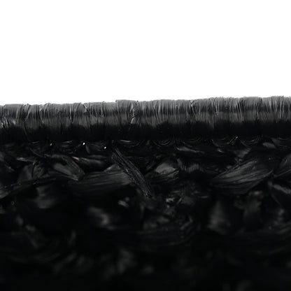 Close-up of black woven raffia-effect texture on the bag surface
