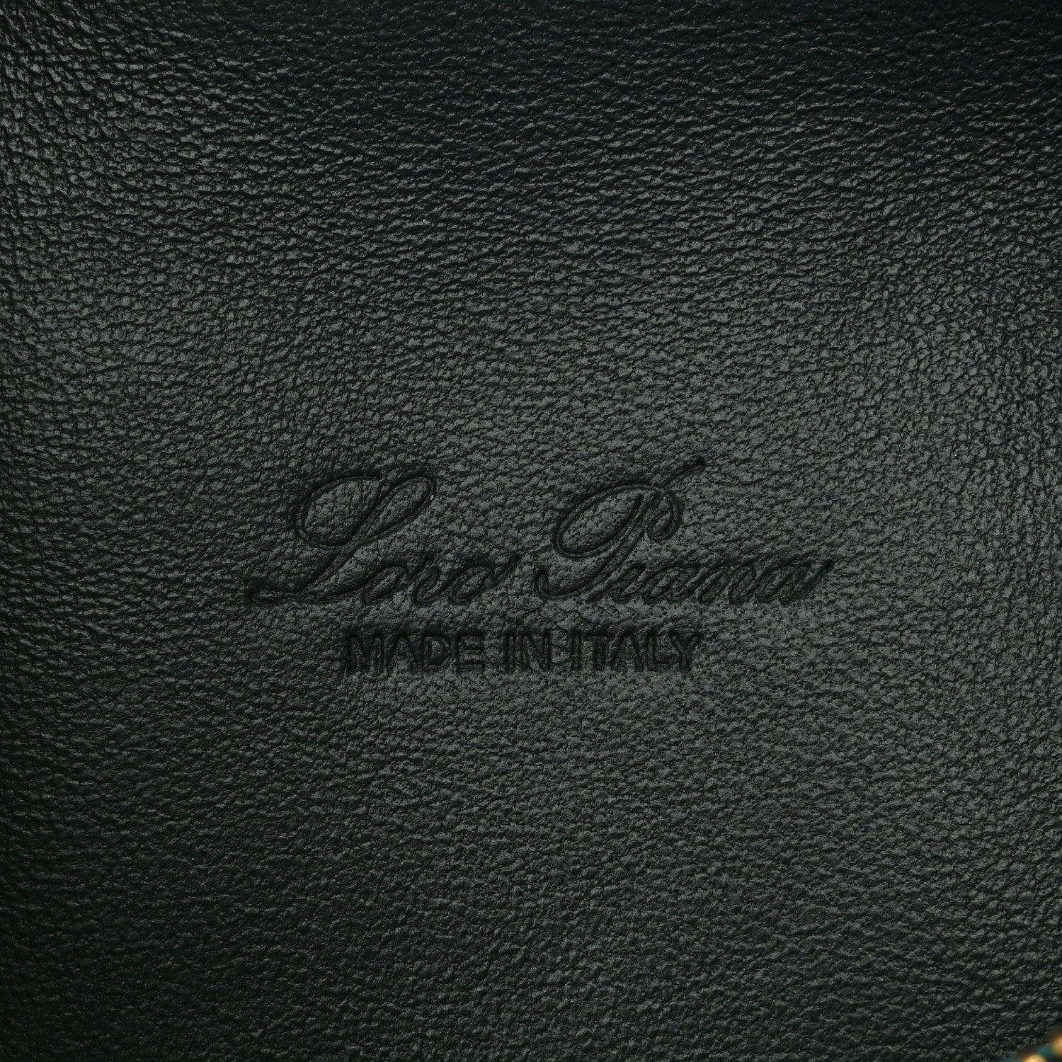 Loro Piana logo stamp on dark green grained calfskin leather pouch.