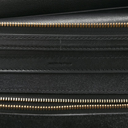 Celine black leather close-up with gold zipper track and stitched panels