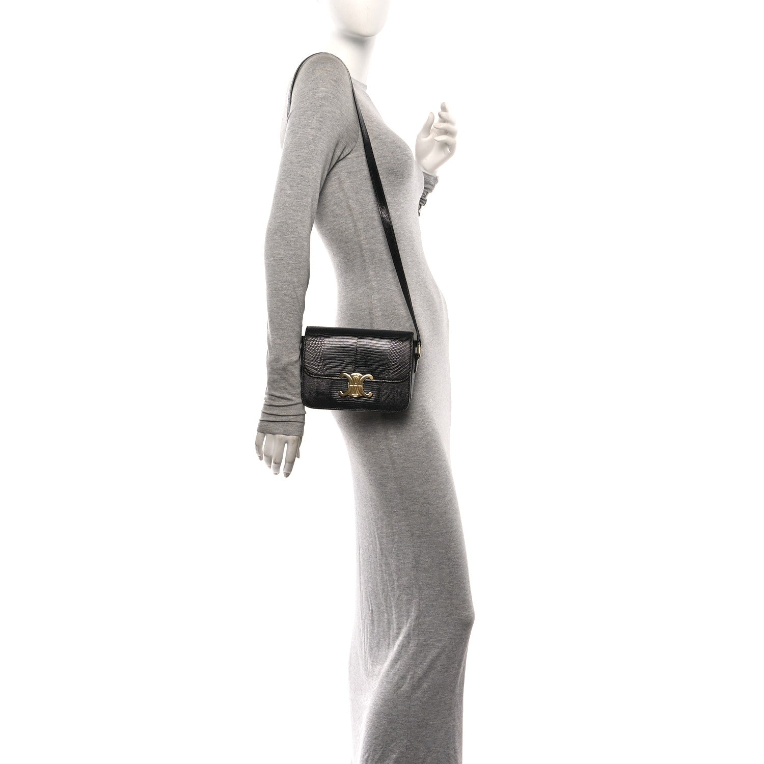 Black lizard-embossed shoulder bag with gold logo clasp, worn on a chain strap