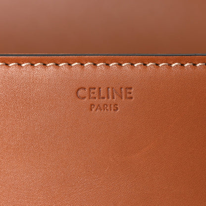Celine embossed mark on tan leather panel with decorative stitched trim.