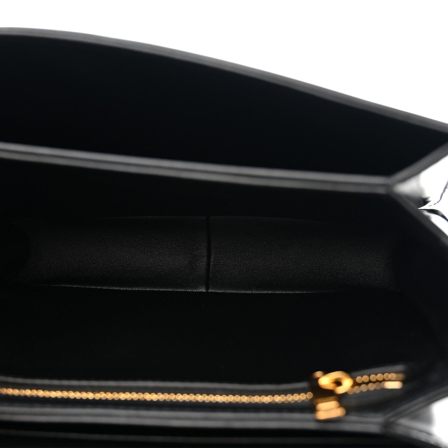 Black leather crossbody bag interior view with gold zipper pull and logo detail.