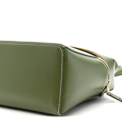 Olive green leather handbag corner detail with gold zipper trim and strap hardware