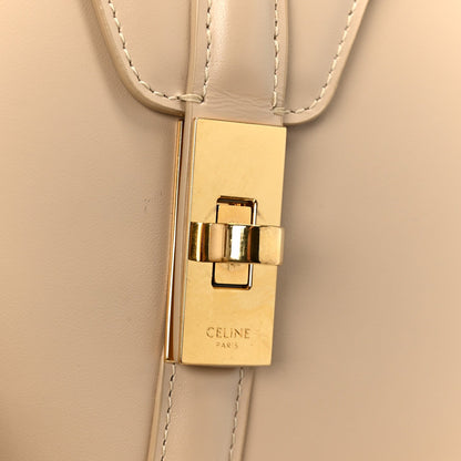 Gold-tone clasp with Celine Paris logo plate on nude leather strap attachment