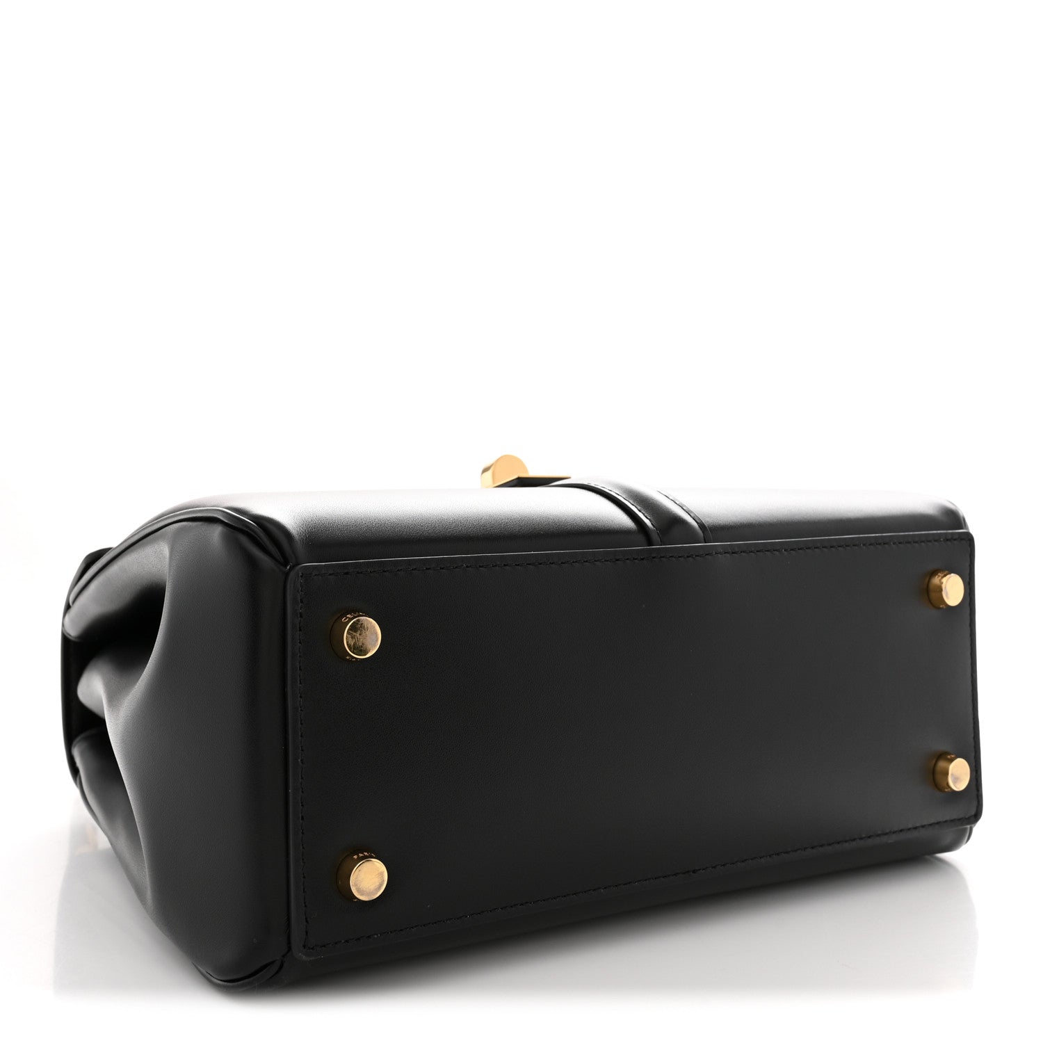 Black structured tote-style bag with top handle and gold snaps on front panel