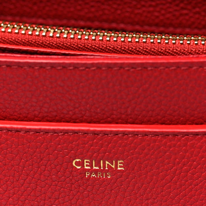 Celine red leather interior label with gold 'CELINE PARIS' embossing.