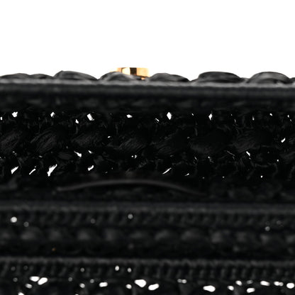 Close-up of black woven raffia-effect fabric trim along the bag edge