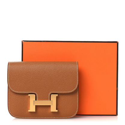 Constance slim wallet in textured tan leather with gold-tone H clasp and front flap