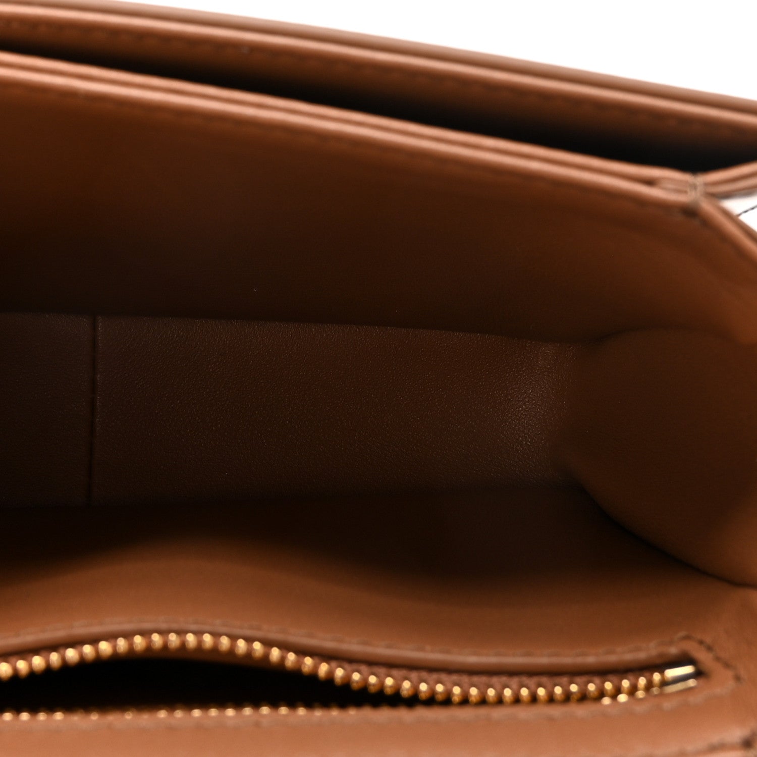 Shiny calfskin bag interior with zipper trim and stitched edge