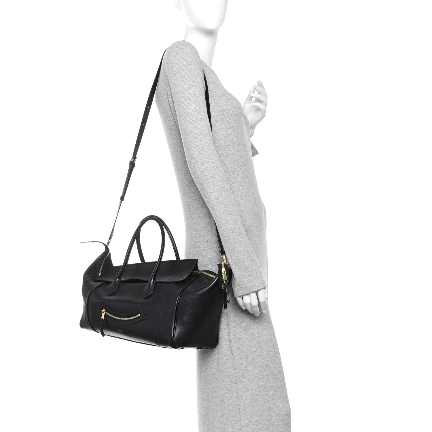 Celine black leather tote with shoulder strap, worn by a model
