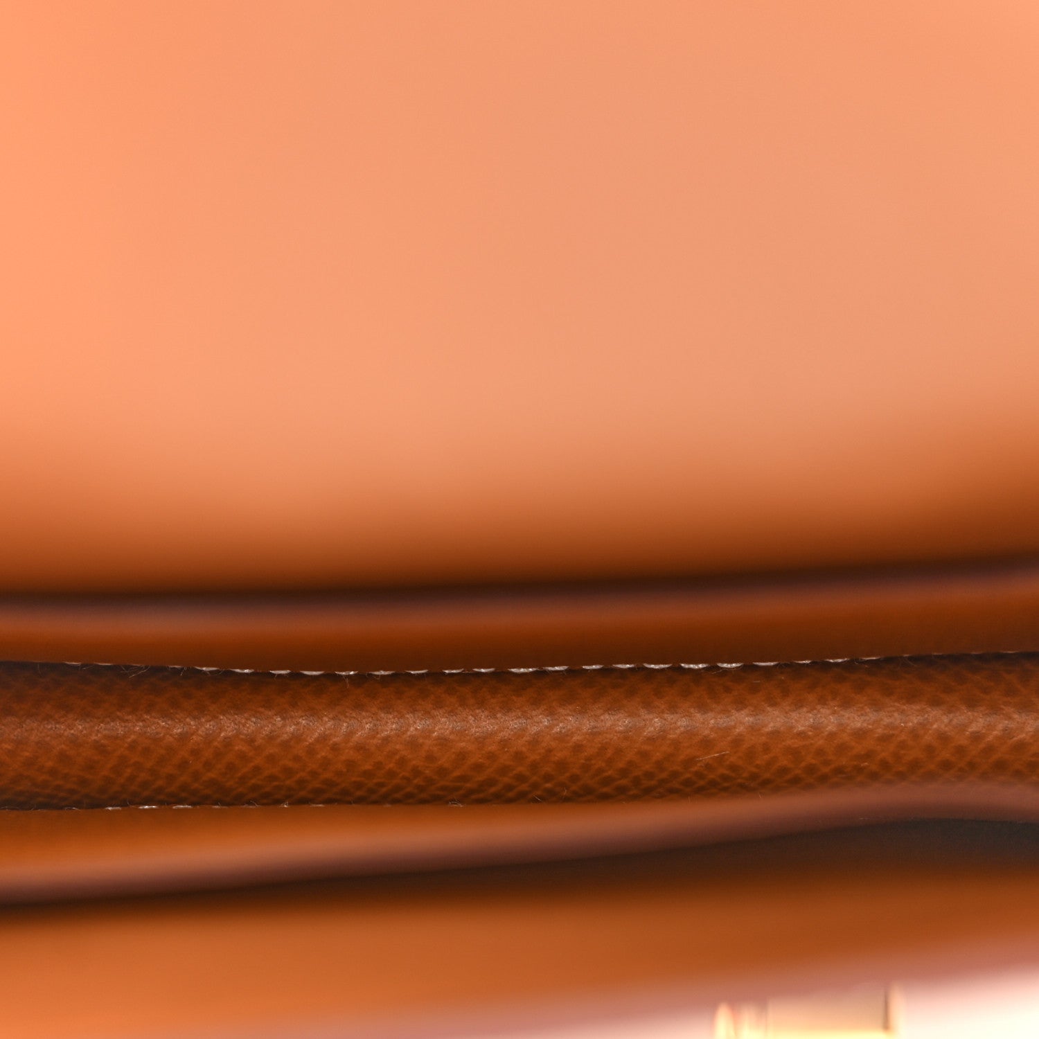 Brown slim wallet with white contrast stitching along the edge, Epsom leather texture.