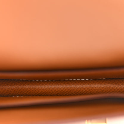 Brown slim wallet with white contrast stitching along the edge, Epsom leather texture.