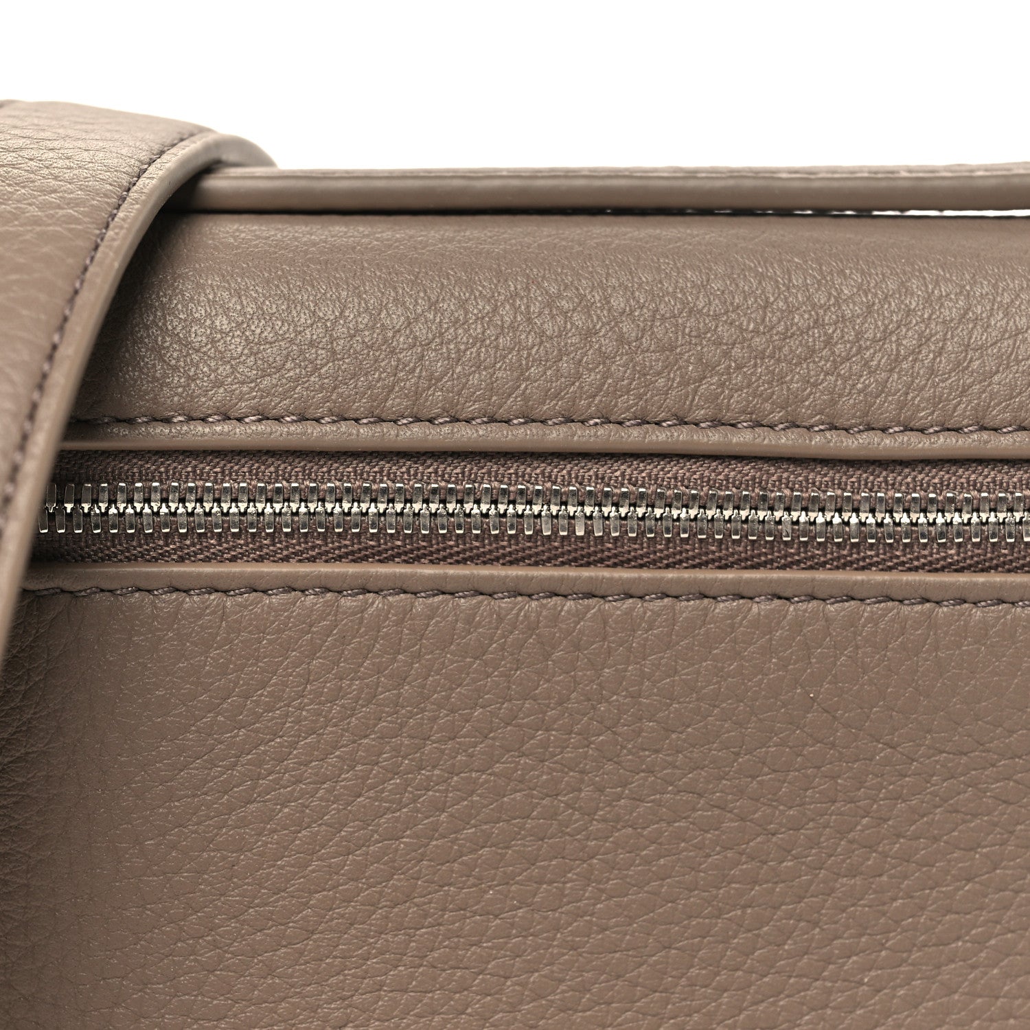 Top zipper and grained leather panel on a mini leather pouch