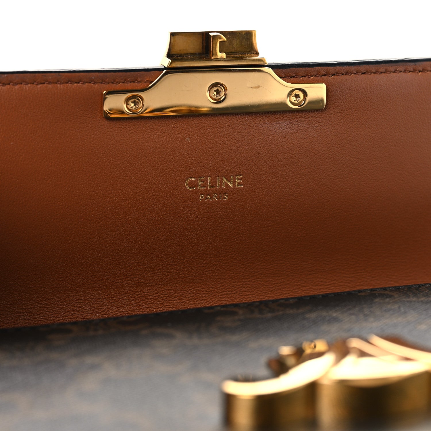 Celine bag clasp with gold hardware and brown leather lining panel