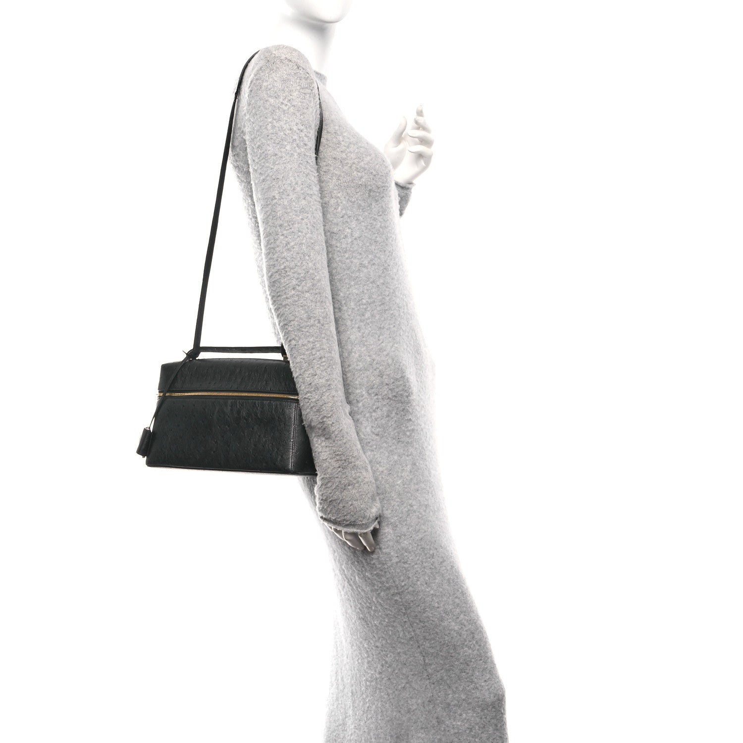 Black ostrich leather crossbody bag with adjustable shoulder strap and top handle.