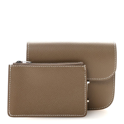 Hermes Constance slim wallet with flap open, textured brown leather and contrast stitching