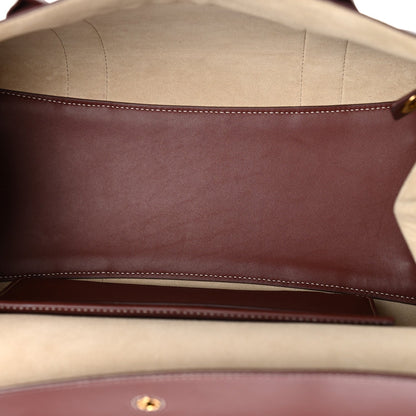 Calfskin bag interior with light lining and stitched edge, dark brown