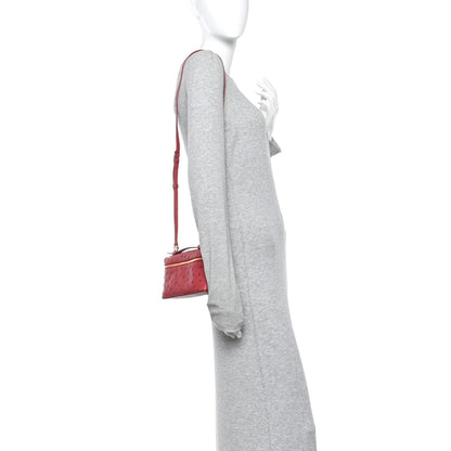 Loro Piana ostrich pouch fuchsia on model with top zip and crossbody strap