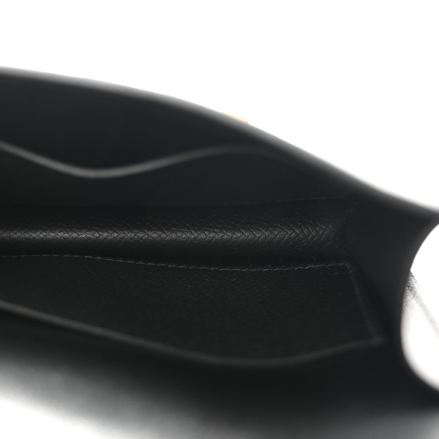 Black textured leather fold seam detail, smooth edge stitching