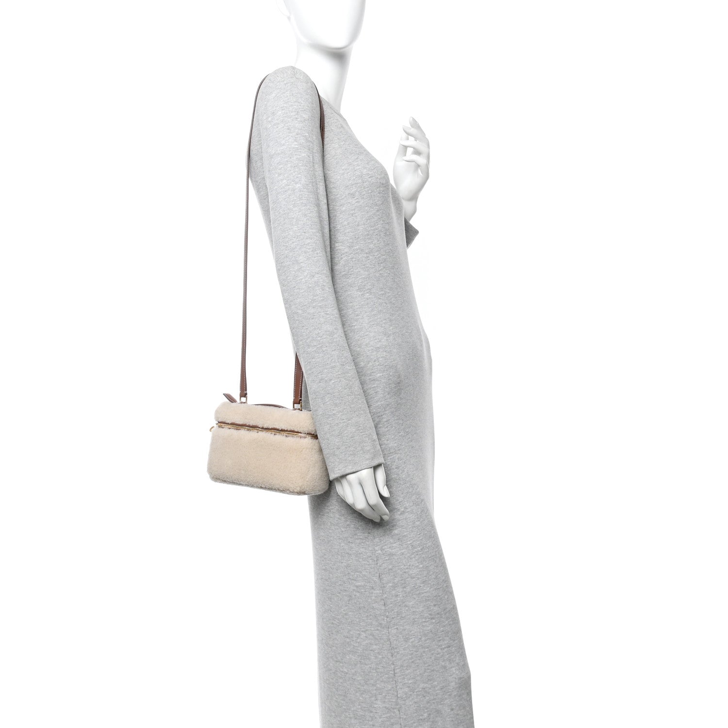 Cream faux-fur crossbody pouch with brown leather strap worn at side