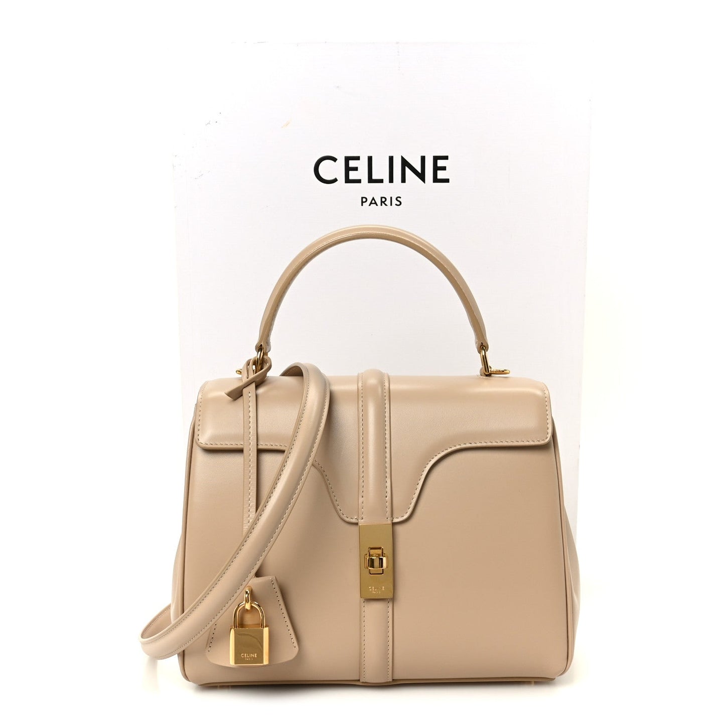 Nude small top-handle bag with top handles, shoulder strap, and gold hardware