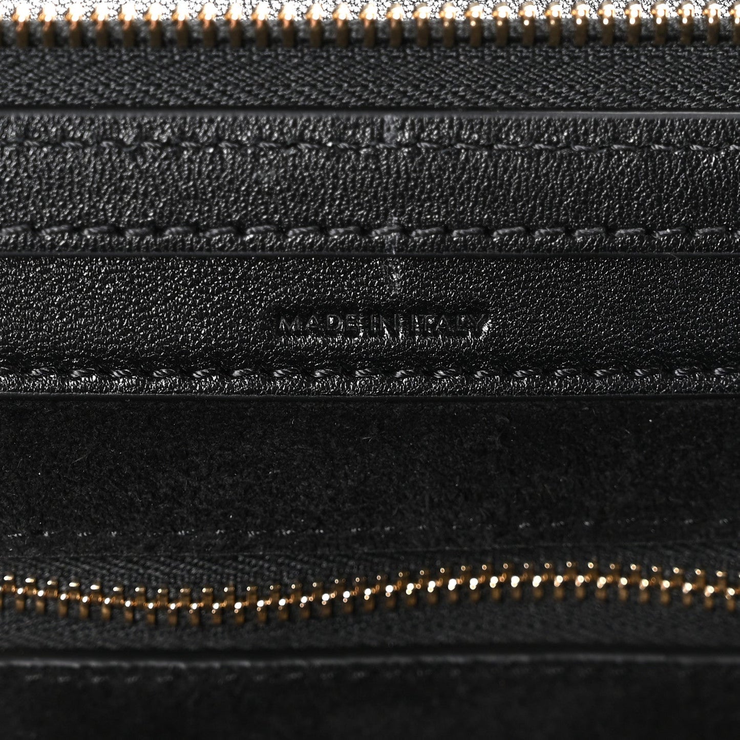 Celine black leather zip pocket close-up with gold-tone zipper teeth