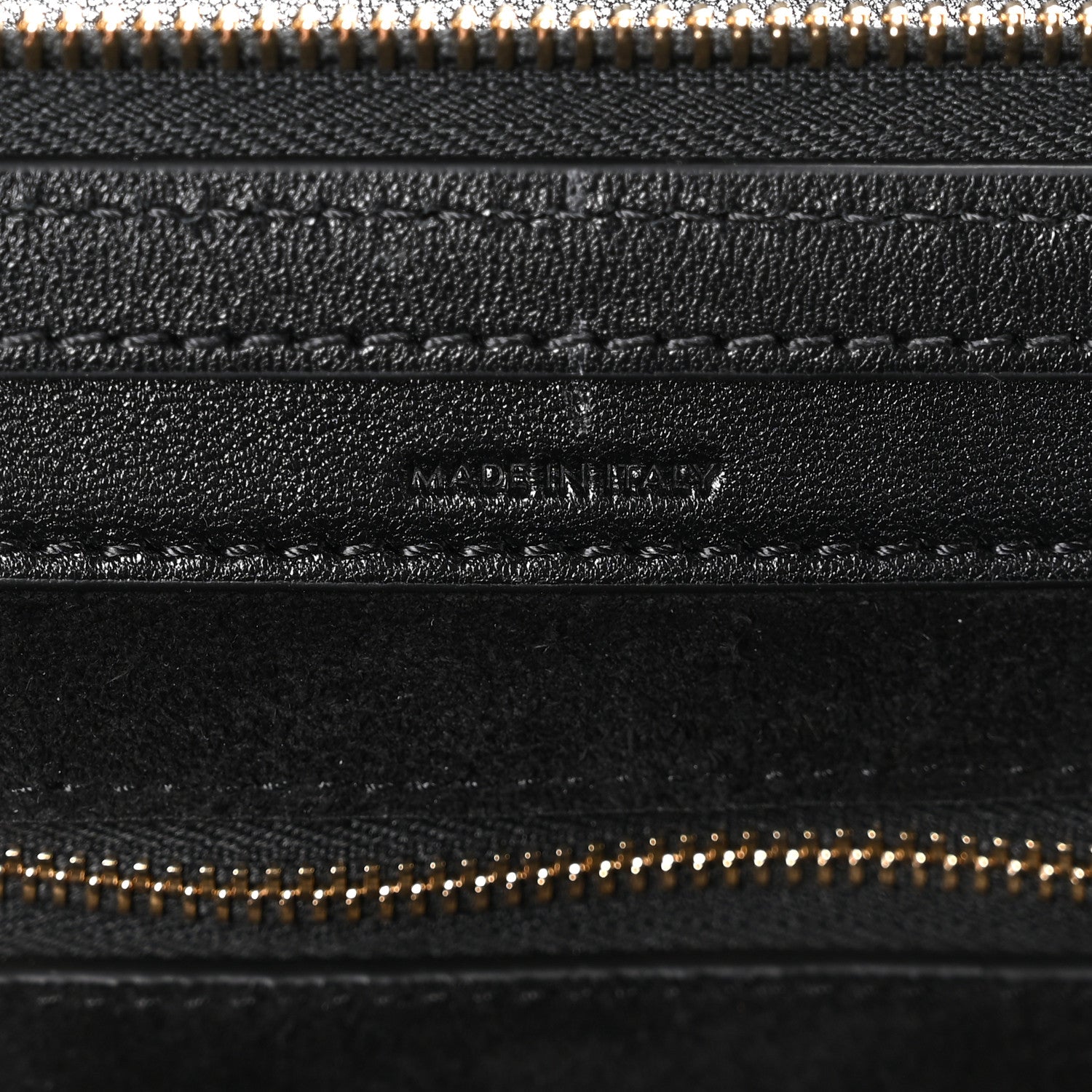 Celine black leather zip pocket close-up with gold-tone zipper teeth
