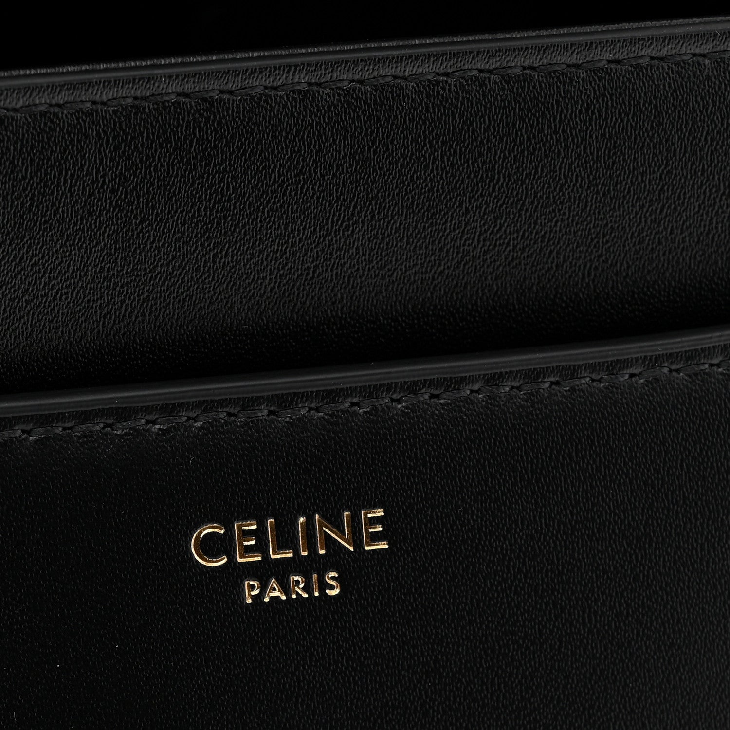 Black leather with CELINE PARIS embossed branding and subtle stitching detail