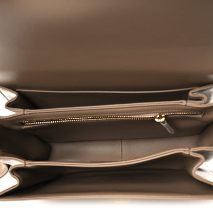 Beige leather bag interior with top zipper and stitched side pocket