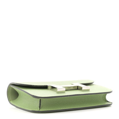 Light green leather slim wallet side view with H clasp hardware