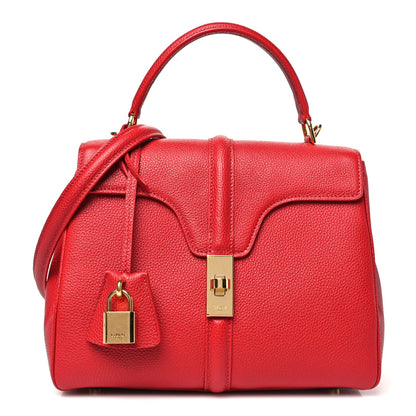Celine small top-handle bag in red grained calfskin with front flap and lock.