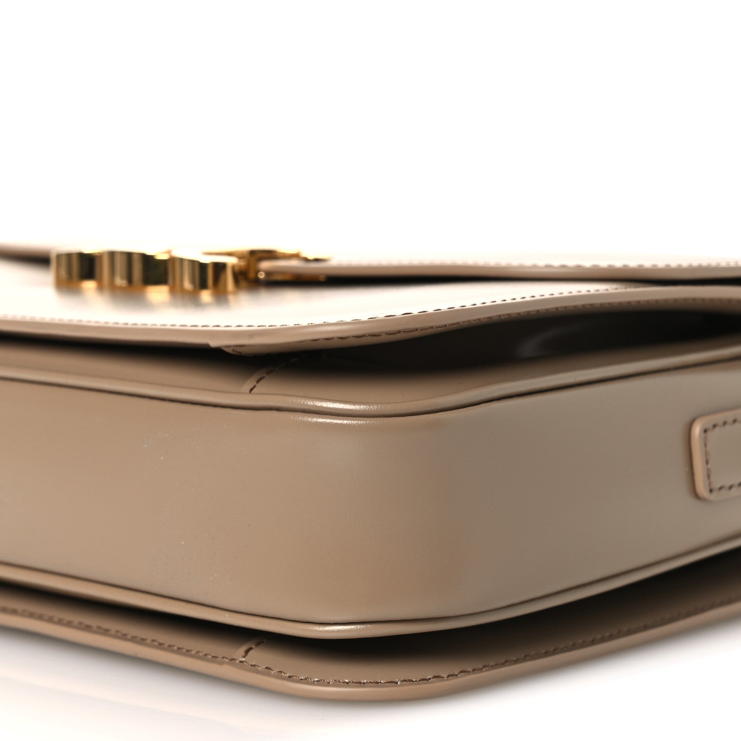 Shiny brown leather shoulder bag with gold-tone clasp hardware and top seam